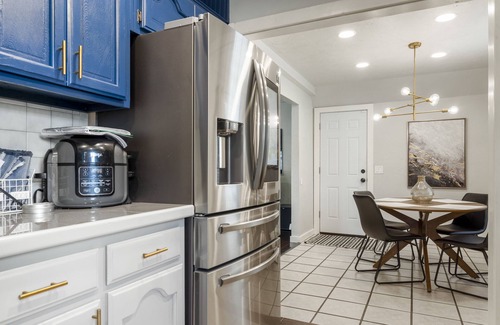 South Tulsa Casa | Modern space in south Tulsa w/ outdoor firepit, kitchen, turf, & string lights!