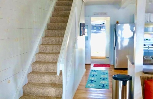 Prudenville Casa | New Listing! Lake front cottage with 100' of private sandy beach