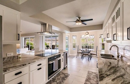 Fort Myers Casa | Offering breathtaking views of the sun setting over the water.