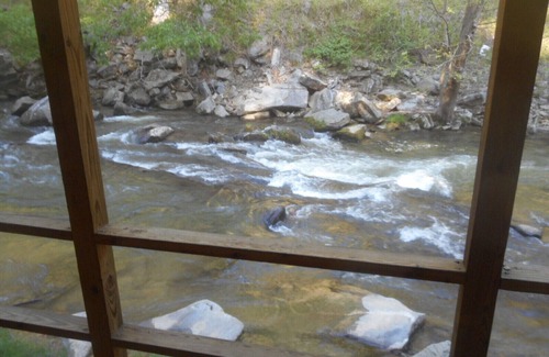 Bat Cave Cabaña | On the River's Edge!! Rocking chairs on large screened porch on river's edge.