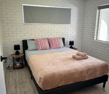 Gold Coast Casa | One bedroom with shared bathroom ground level of a two-story house