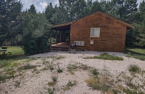 Rosebud Cabina | One of two rustic cabins nestled in Rosebud Sicangu Lakota Oyate pine forest.