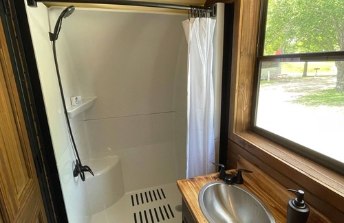Branson Cabaña | Oregon Trail Wagon has two queens size bed, bathroom w/ shower, heat & a/c, smart tv, wi-fi, microwa