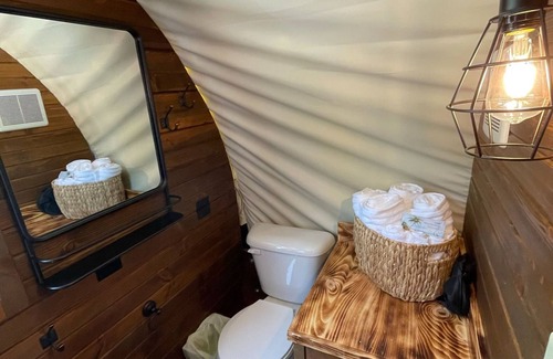 Branson Cabaña | Oregon Trail Wagon has two queens size bed, bathroom w/ shower, heat & a/c, smart tv, wi-fi, microwa