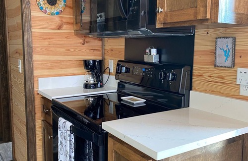 New London Casa | Phoenix Tiny House at Badin Shores Resort, lake view, porch, pool, beach, marina