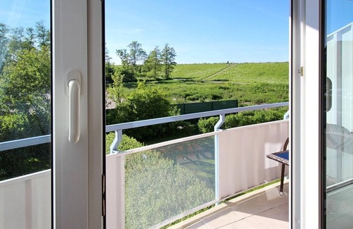 Schillig Apartamento | Pretty vacation apartment by the sea with balcony and view of the green North Sea dike - Hus