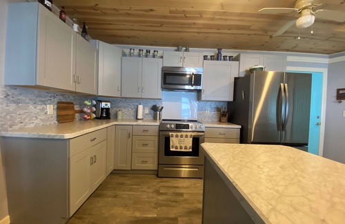 Little Sturgeon Casa | Prime sunsets, great kayaking, huge yard, volleyball court, and free firewood