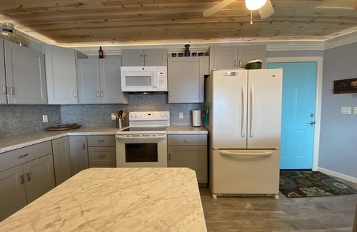 Little Sturgeon Casa | Prime sunsets, great kayaking, huge yard, volleyball court, and free firewood