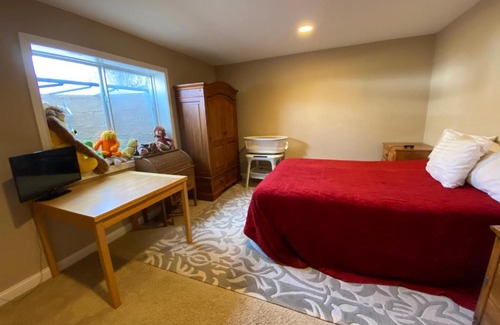 Maxwell Casa | Private basement bedroom with private bathroom, kitchen, and living room with large screen television
