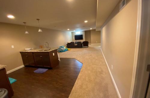 Maxwell Casa | Private basement bedroom with private bathroom, kitchen, and living room with large screen television