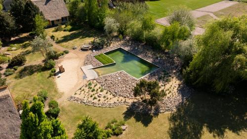 Krienke Casa | Reetdachhaus Kranich mit Schwimmteich in Krienke