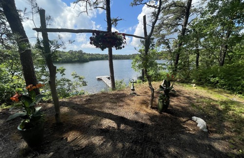 Harwich Casa | Relax in a tranquil log home on direct lake front property. The Hermitage awaits