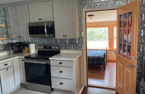 Carrabelle Cabaña | Remodeled historic cottage with a peek of the Gulf of Mexico.