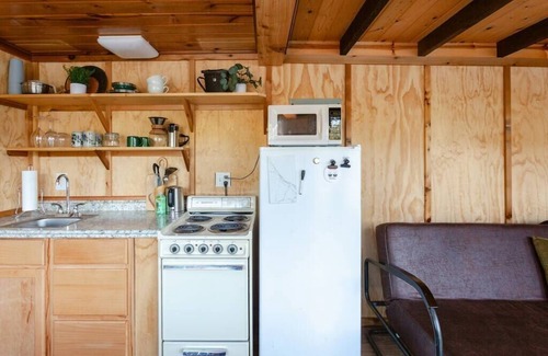 Lakeside Cabina | Remote 1 BR Lakefront Cabin. Features a King loft bed with lake views, private dock, and provided paddleboards/kayaks. Perfect for fishing, stargazing, and quiet nature escapes.