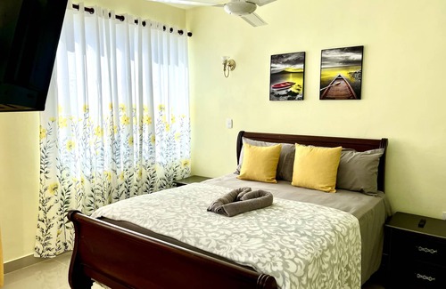 Higuey Hotel | Romantic Hispanic 304 private room with refrigerator and dining area.