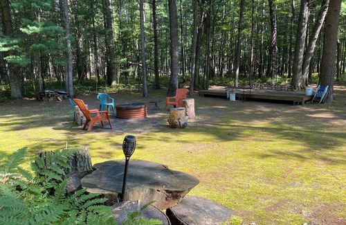 Prudenville Casa | Rustic home on wooded lot, very private. Lake and dock access. Close to trails.
