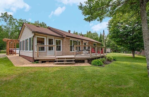 Kearney Cabaña | Sand Lake Getaway - Modern Riverfront Cottage w/ Swimming & Hot Tub