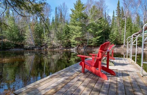 Kearney Cabaña | Sand Lake Getaway - Modern Riverfront Cottage w/ Swimming & Hot Tub