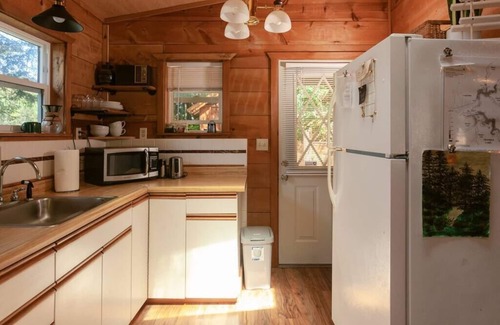 Lakeside Cabina | Secluded 1-bedroom lakefront cabin in Lakeside, OR. Ideal for writers or couples seeking solitude. Features a King bed, wood stove, kayak for 2, and stargazing from your private dock.