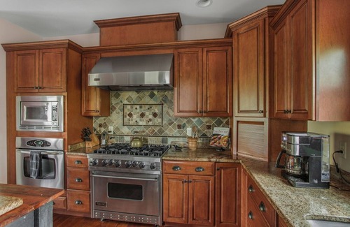 Huntly Casa | Secluded 4 bedroom log style home with screened porches, deck and fishing pond.