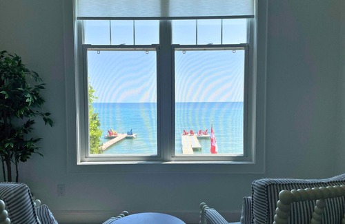 Big Bay Point Cabaña | Shallow Beach Lakefront Cottage perfect with Kayak, Firepit, BBQ + Playground