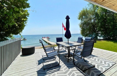 Big Bay Point Cabaña | Shallow Beach Lakefront Cottage perfect with Kayak, Firepit, BBQ + Playground