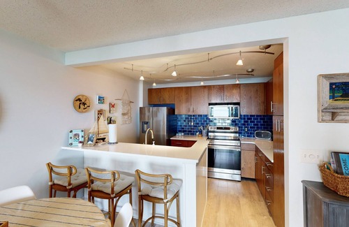 Maple City Condominio | Single-level lakefront hideaway with a deck, fireplace, & washer/dryer