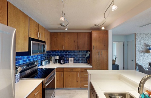 Maple City Condominio | Single-level lakefront hideaway with a deck, fireplace, & washer/dryer
