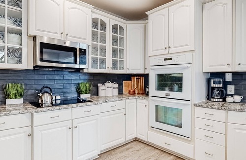 Sunset Island Casa | Spacious beachside home with fireplace, washer/dryer, pools, dock, & gym