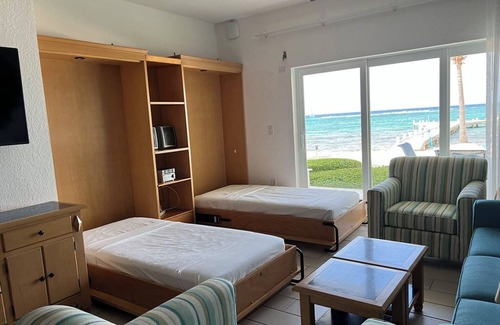 Colliers Bay Complejo | Step onto beach! Beach front 2 bed + bath condo with full kitchen, LR/DR, patio