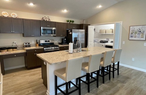 Okahumpka Casa | Stylish home with gourmet kitchen, dual garages, and private golf cart!