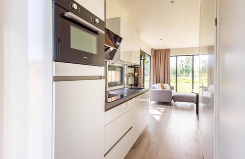 Kotten Casa | The 6-person holiday villa Amalia with a private sauna has a spacious living room, an open kitchen, three bedrooms, and a spacious terrace.