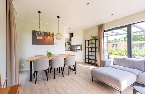 Kotten Casa | The 6-person holiday villa Amalia with a private sauna has a spacious living room, an open kitchen, three bedrooms, and a spacious terrace.