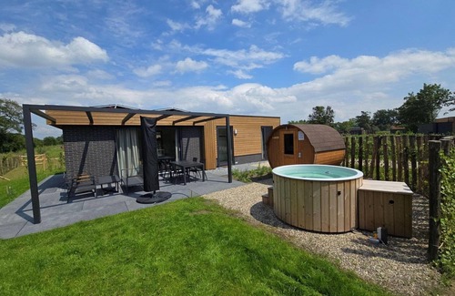 Lattrop Casa | This holiday home with a private sauna and hot tub features a cozy, homely living room with an open kitchen, 2 bedrooms, and a spacious outdoor area