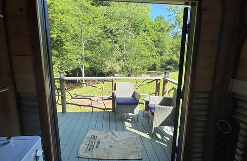 Hillsville Cabina | Tiny cabin sits by a bubbling, stocked creek. Pet friendly for a fee, hot tub