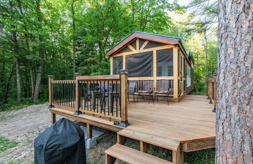 Nevis Casa | Tiny house nestled in the woods with lake view. Pets Accepted!