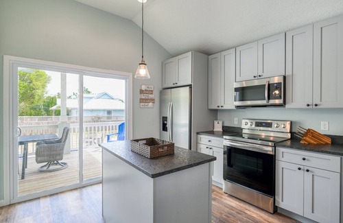 Butler Beach Casa | Tropical Winds - Heated Pool & Firepit! Walk to the Beach!