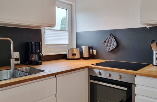 Kalifornien Apartamento | Vacation apartment "Achtern Diek 3" 1st row on the Baltic Sea coast, dog-friendly