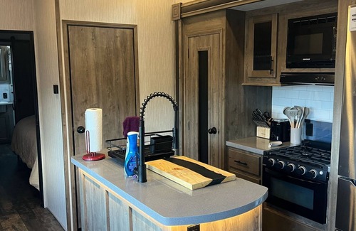 Lakeside Casa | Vacation Camper with private area behind with Seating, Firepit, and Hot tub