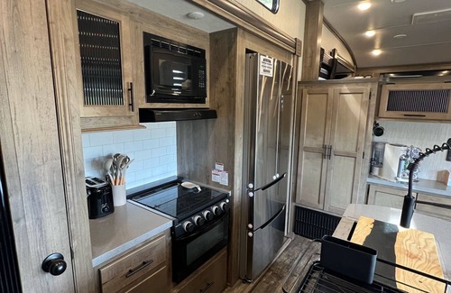Lakeside Casa | Vacation Camper with private area behind with Seating, Firepit, and Hot tub