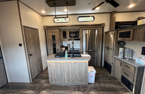 Lakeside Casa | Vacation Camper with private area behind with Seating, Firepit, and Hot tub