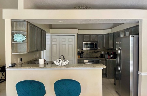 Palm River Estates Casa | Vibrant home close to best beach parks and shops backyard pool with a lake