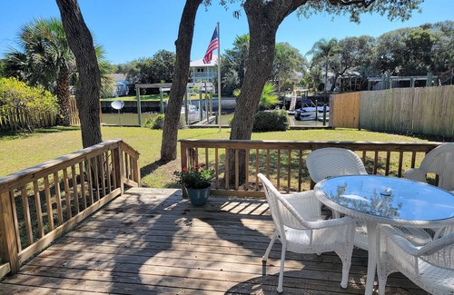 Butler Beach Cabaña | Wake up to an amazing sunrise from your wood deck with outdoor furniture