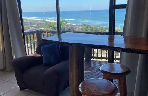 Warner Beach Cabaña | Wake up to gorgeous sunrises and sea views upon a wooden balcony.