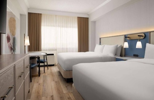 White Plains Hotel | Warm and Comfortable Pets Allowed Two Queen Room w/ Pool and Airport Shuttle