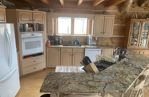 North Algona Wilberforce Cabaña | Waterfront log home on Lake Dore. Decks, dock, outdoor hot tub and fire pit.
