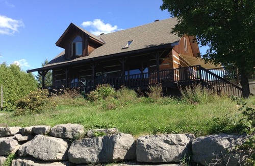 North Algona Wilberforce Cabaña | Waterfront log home on Lake Dore. Decks, dock, outdoor hot tub and fire pit.