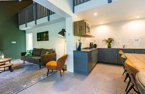 Norg Casa | When staying in this 12-person bungalow, you don't have a garden, but a whole forest! On the terrace, you can enjoy the outdoors.
