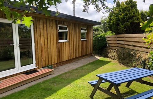 Stenalees Cabina | Woodpecker - our cosy, spacious glamping cabin at Mena Farm, Cornwall