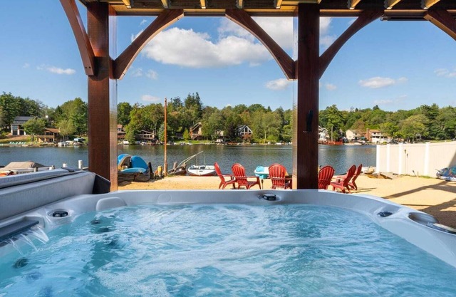 Luxurious 6-bedroom lakefront Poconos home with a deck, private beach, fire pit and hot tub